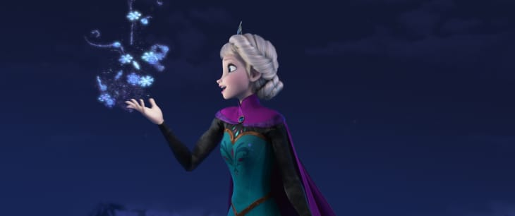 Woman with braided hair in a teal dress and purple cape conjures snowflakes in a dark, starry night.