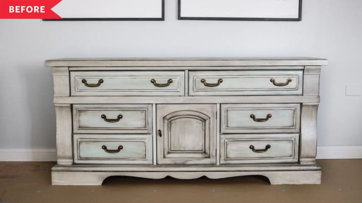 Distressed white dresser with brass handles and six drawers.