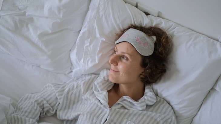 Woman smiling alone in bed