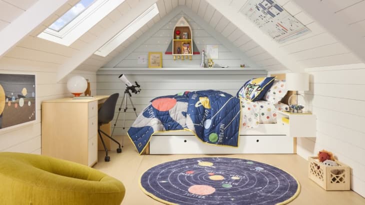 solar system rug, solar system comforter, telescope, rocket ship shelf, storage bed, wood desk, angled ceiling, skylight, paneled walls, solar system art