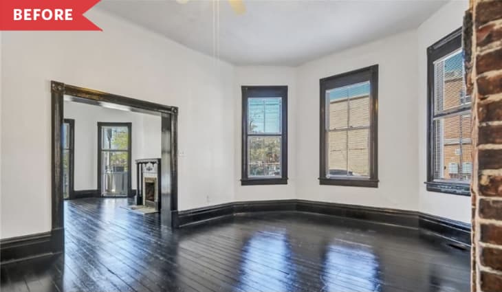 Before: Large front room with dark trim, white walls, and brick fireplace