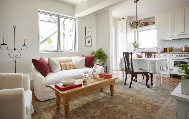 Living room with large tan carpet white couch and dining-room table