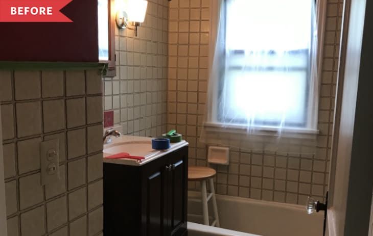 Before: Bathroom with white square tile and red paint on the walls, plus dark wood vanity