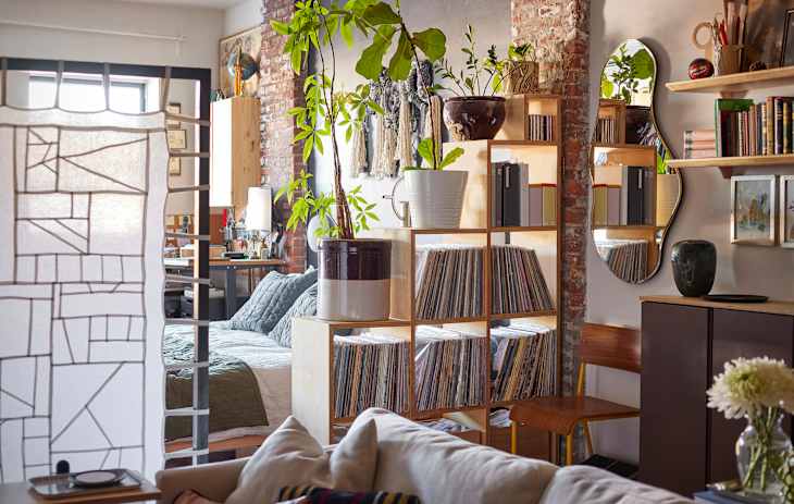 A fabric room divider flanked by stacks of record storage shelf.