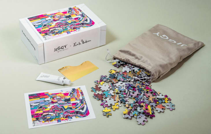 A colorful jigsaw puzzle with the pieces spilled out