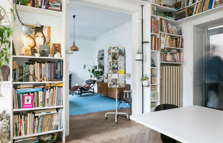 Floor-to-ceiling bookshelves are installed in a dining room