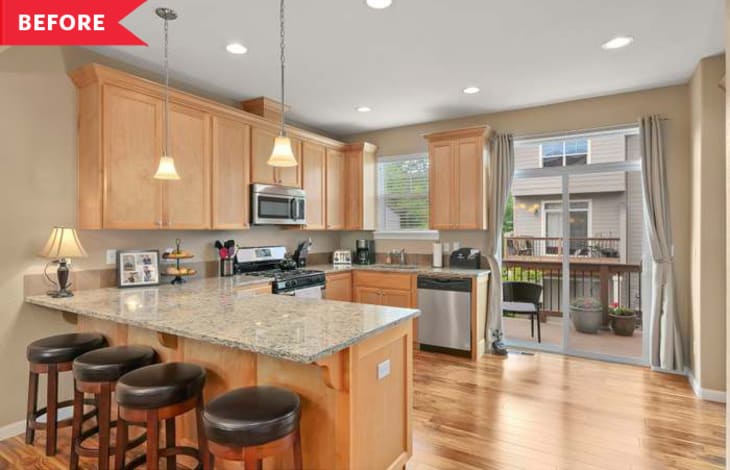 Spacious kitchen with light wood cabinets, granite island, bar stools, stainless steel appliances, and sliding glass doors.
