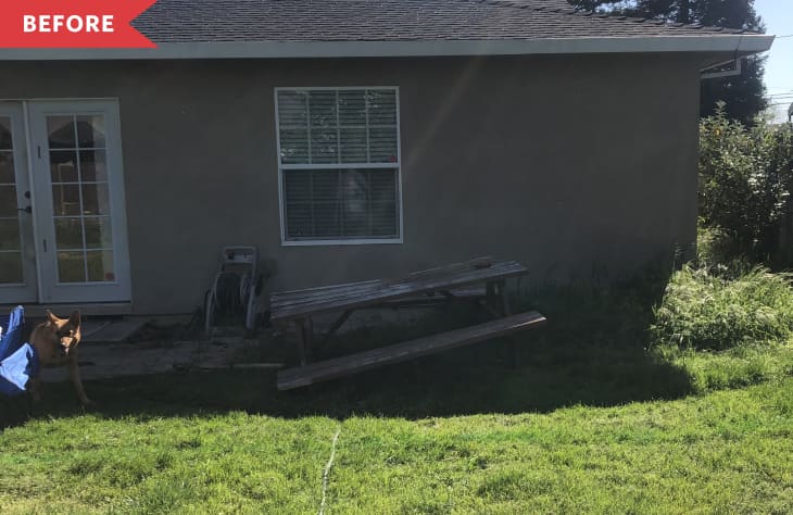 Before: exterior of house with grassy backyard and no patio