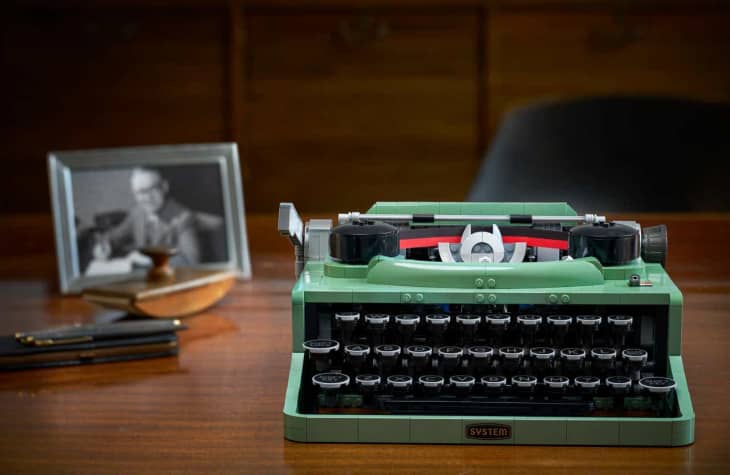 Green typewriter made of LEGOs on desk
