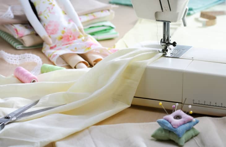 Sewing machine with fabric, scissors, and pin cushion