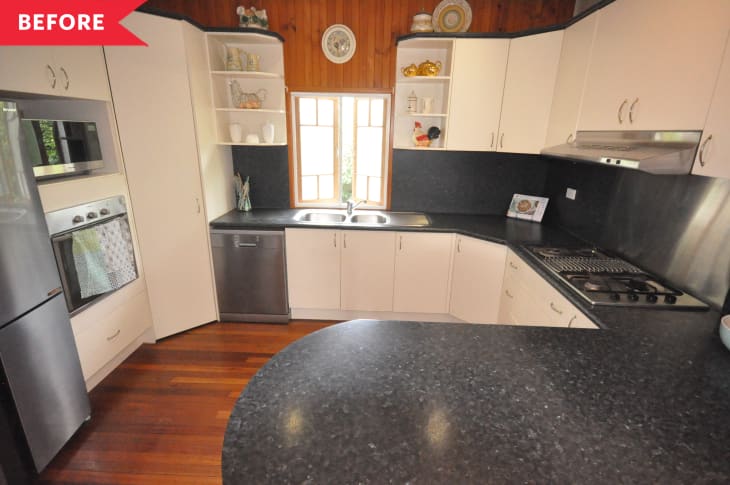 Before: Dated kitchen with wood paneling and rounded black melamine counters