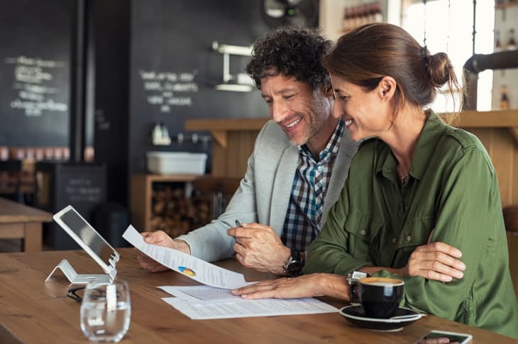 Couple sitting in coffee shop discussing finances