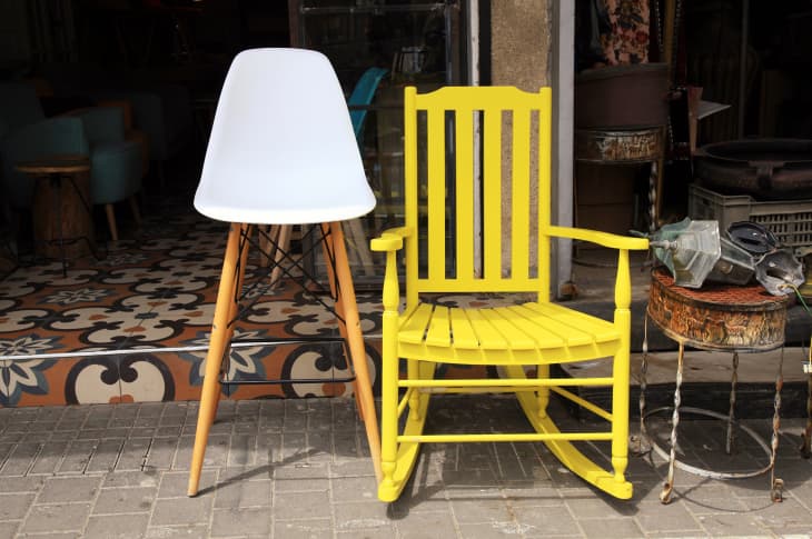Vintage yellow rocking chair and lamp on street flea market