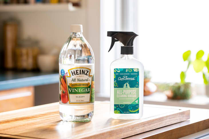 Bottle of cleaning vinegar and cooking vinegar on kitchen counter