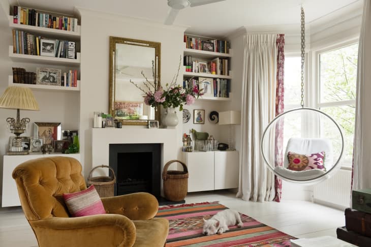 Living room with Eero Aarnio hanging bubble chair and vintage brown armchair