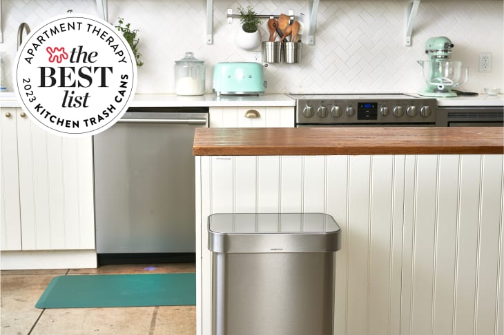 2023 Best Kitchen Trash Cans seal in front of photo of kitchen with a stainless steel trashcan.
