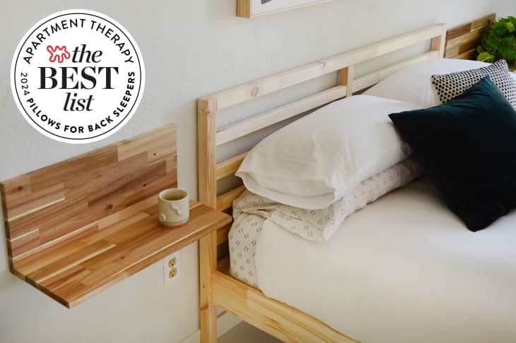 Bed made with lots of pillows with Best List Seal beside.