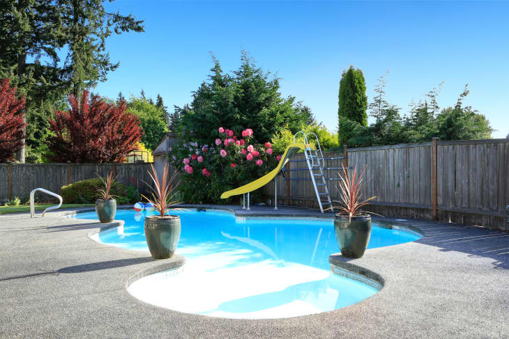 https://cdn.apartmenttherapy.info/image/upload/f_auto,q_auto:eco,c_fit,w_730,h_487/Fenced%20backyard%20with%20small%20beautiful%20swimming%20pool%20and%20playground%20shutterstock_447557716