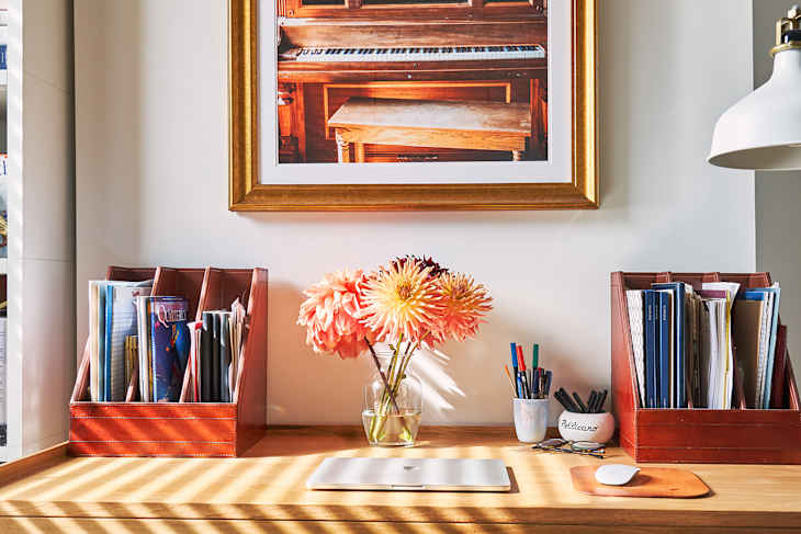 Dahlias in vase on home office desk.