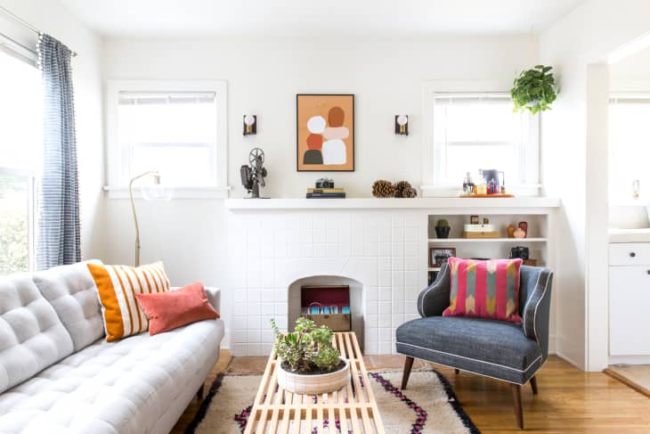 A sun-inviting white living room with colorful decor accents