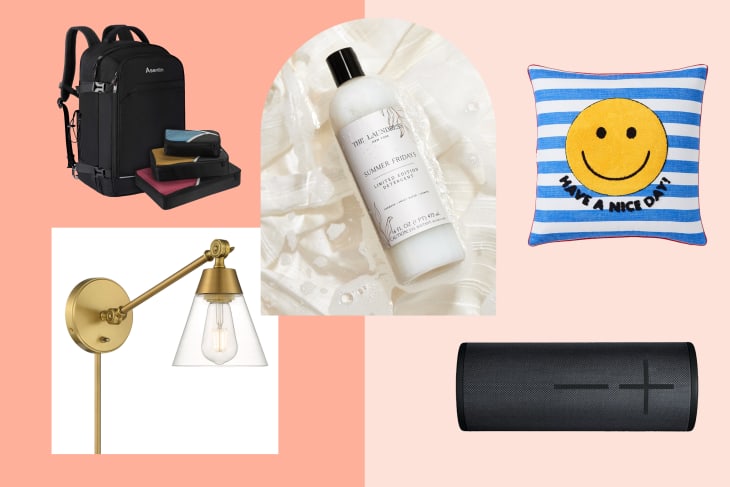 Black backpack, colorful packing cubes, lotion bottle, striped pillow with smiley face, gold wall sconce, black speaker.