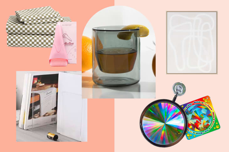 Checkered bed sheets, pink face roller, glass with lemon, abstract art, book holder, and colorful spinning top.