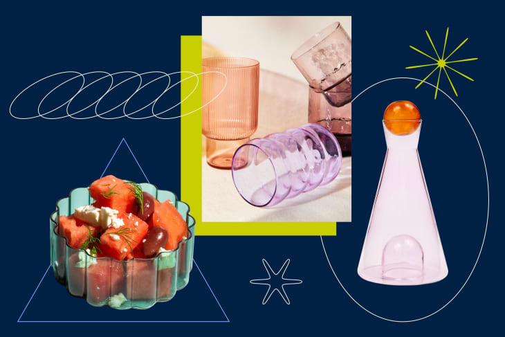 Colorful glassware and a bowl of tomatoes, olives, and feta on a geometric, abstract background.