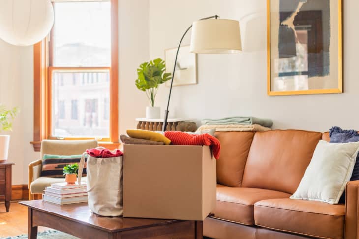 cardboard box with clothes on coffee table