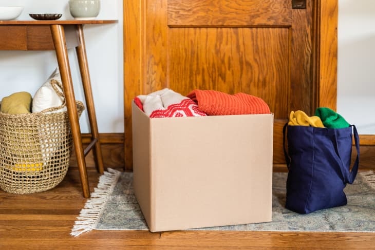 cardboard box filled with clothing in home