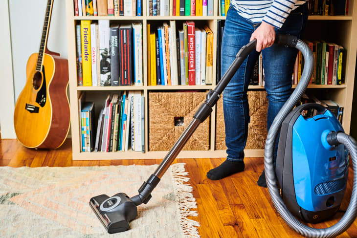 someone vacuuming home rug