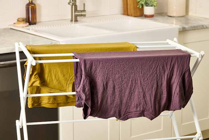 head on shot of clothes drying on a drying rack in a kitchen