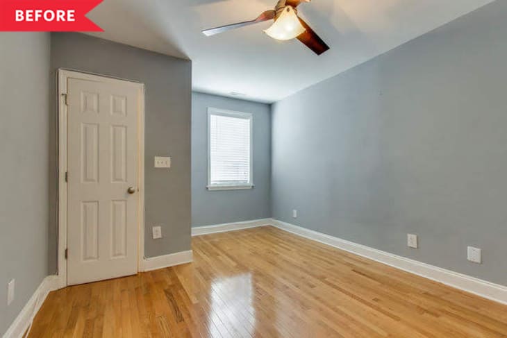 Empty room with gray walls, wooden floor, ceiling fan, and a window next to a closed white door.