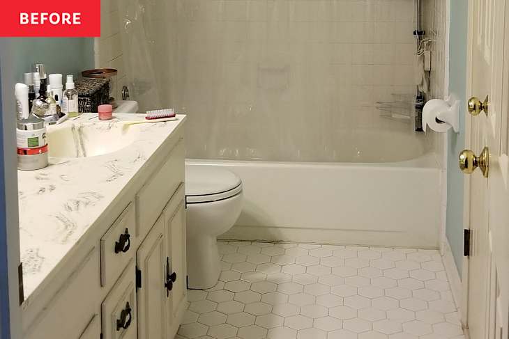 Bathroom with a white vanity, hexagonal tile floor, and a shower curtain covering the bathtub. Various toiletries are on the counter.