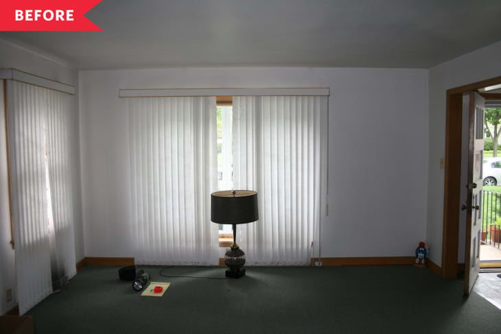 Before: Dark living room with green carpet and no decor