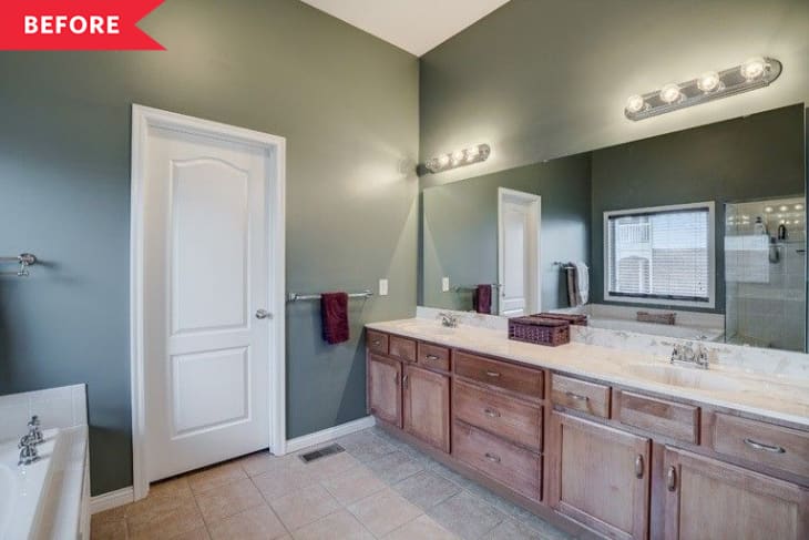 Before: green bathroom with wood vanity and beige floor tile