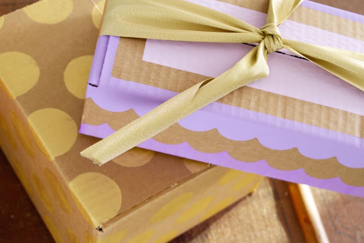 cardboard boxes decorated with paint and ribbon