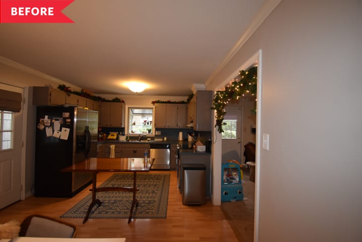 Small kitchen with cabinetry on outer edges and large table in center