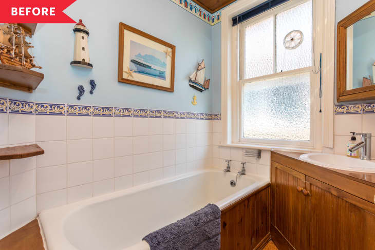 Before: Bathroom with natural wood vanity, blue walls, and nautical decor