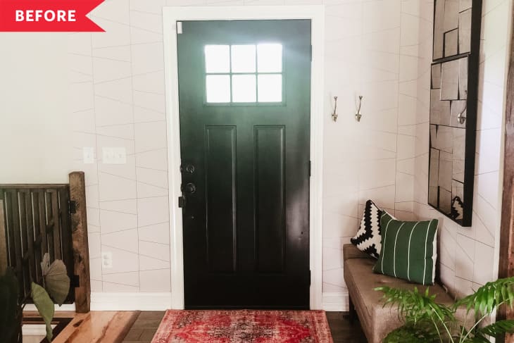 Before: white entryway interior with white walls, black door, and wood floors