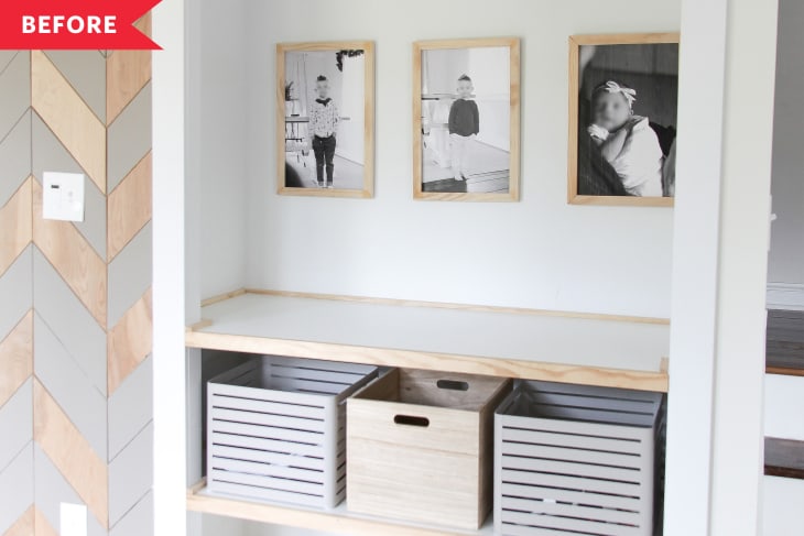 entryway before remodel with white walls, light wood framed shelves, framed portraits