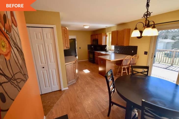 Kitchen with wooden cabinets, round dining table, chairs, and sliding glass door leading to a deck.