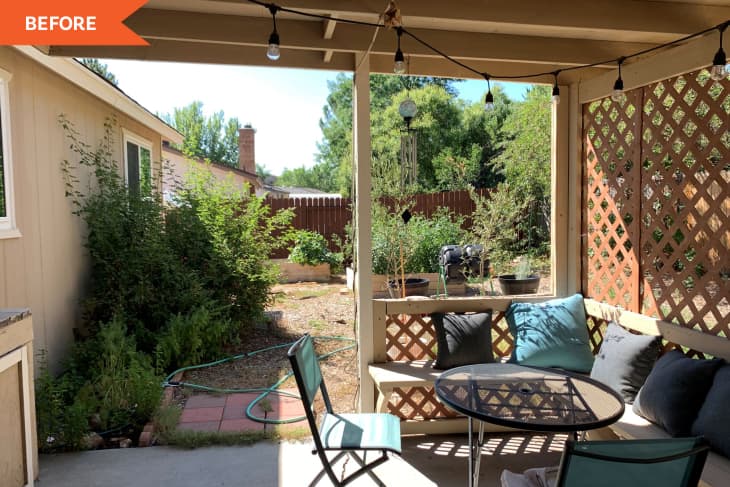 Covered patio with string lights, lattice walls, outdoor seating, and a small round table overlooking a garden area.