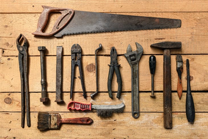 Assortment of vintage hand tools on a wooden background