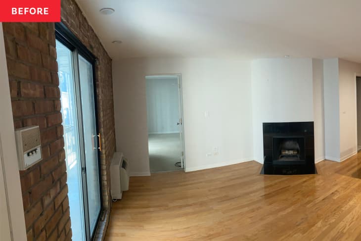 Before: Empty living room with exposed brick wall and fireplace in corner