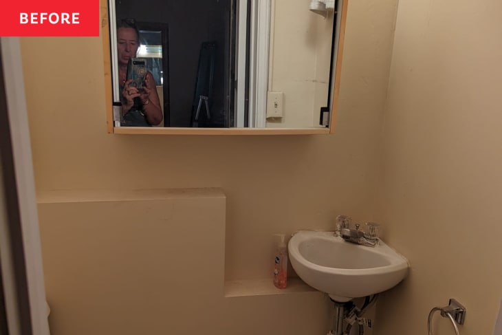 Before: a tan bathroom with a square mirror over a sink