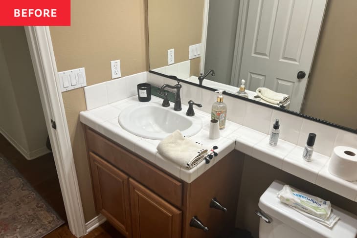 Before: a bathroom sink with brown cabinets and a tan wall