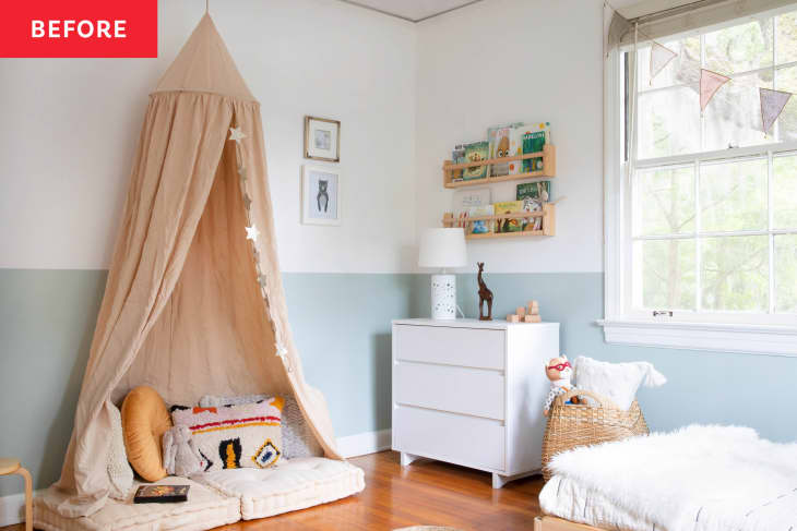 A kids' bedroom with half-walls painted blue, white furniture, and a sand-colored canopy above a reading nook.