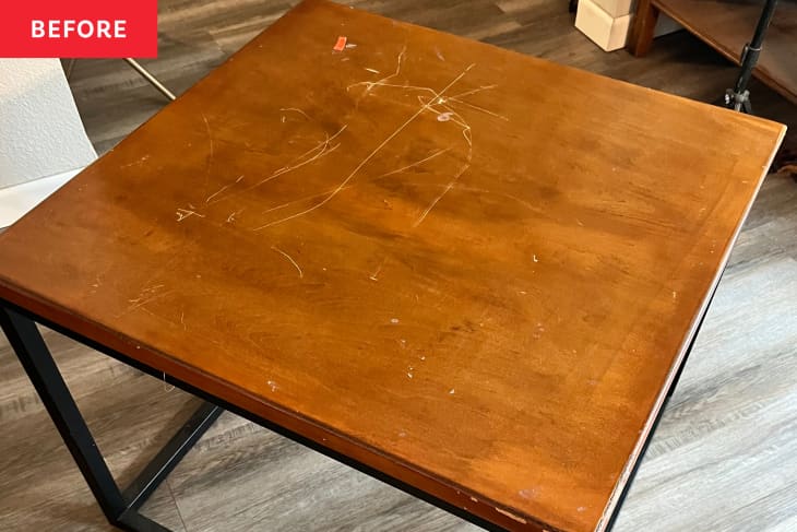 Before: Scratched wood-look table with black legs