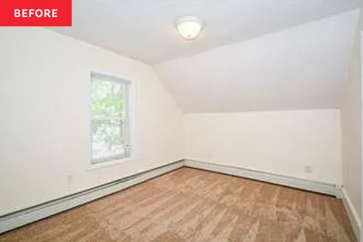 Empty attic room with beige walls, single window, and carpeted floor.