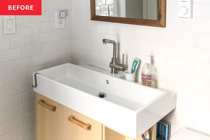 Before: a white bathroom sink against white tile walls